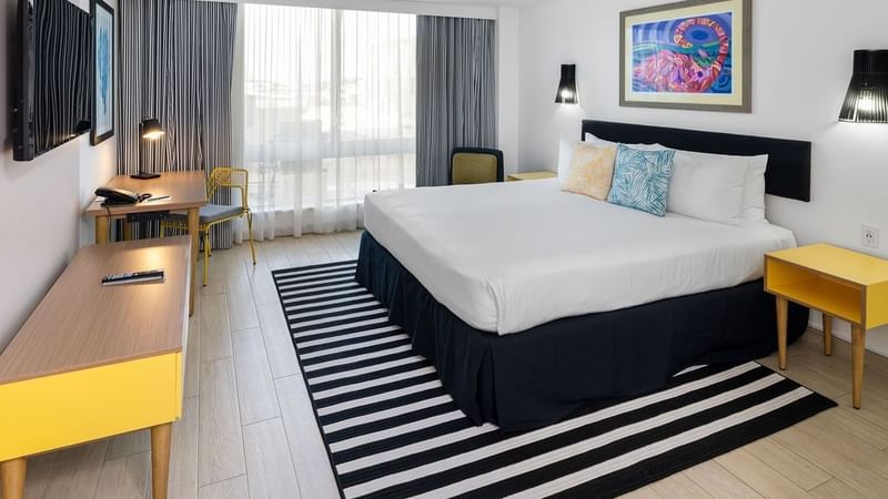 King-size bed, a TV & a wheelchair in Island View Accessible at Warwick Paradise Island Bahamas