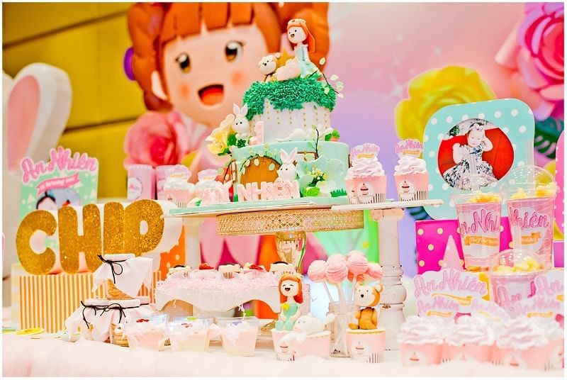 Dessert table featuring a whimsical cake and sweet treats with a cartoon character backdrop at Park Hyatt Saigon