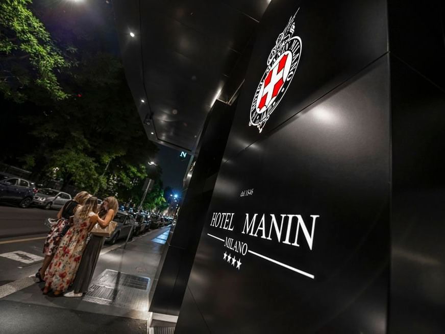 Hotel name board displayed in front of Manin Hotel Milano