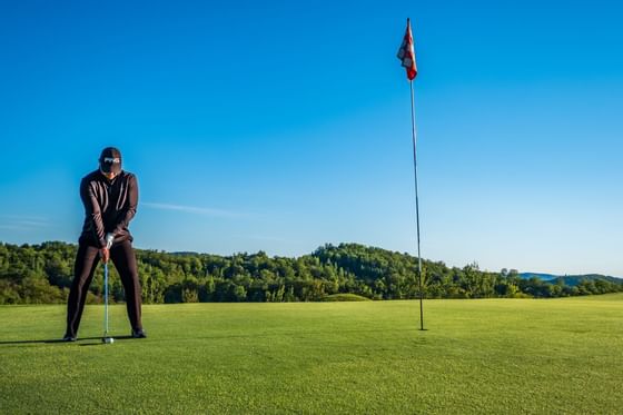 A man playing golf at Hotel Mont Gabriel Resort & Spa