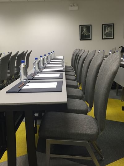 Close-up of classroom-style table setting at Kinzie Hotel
