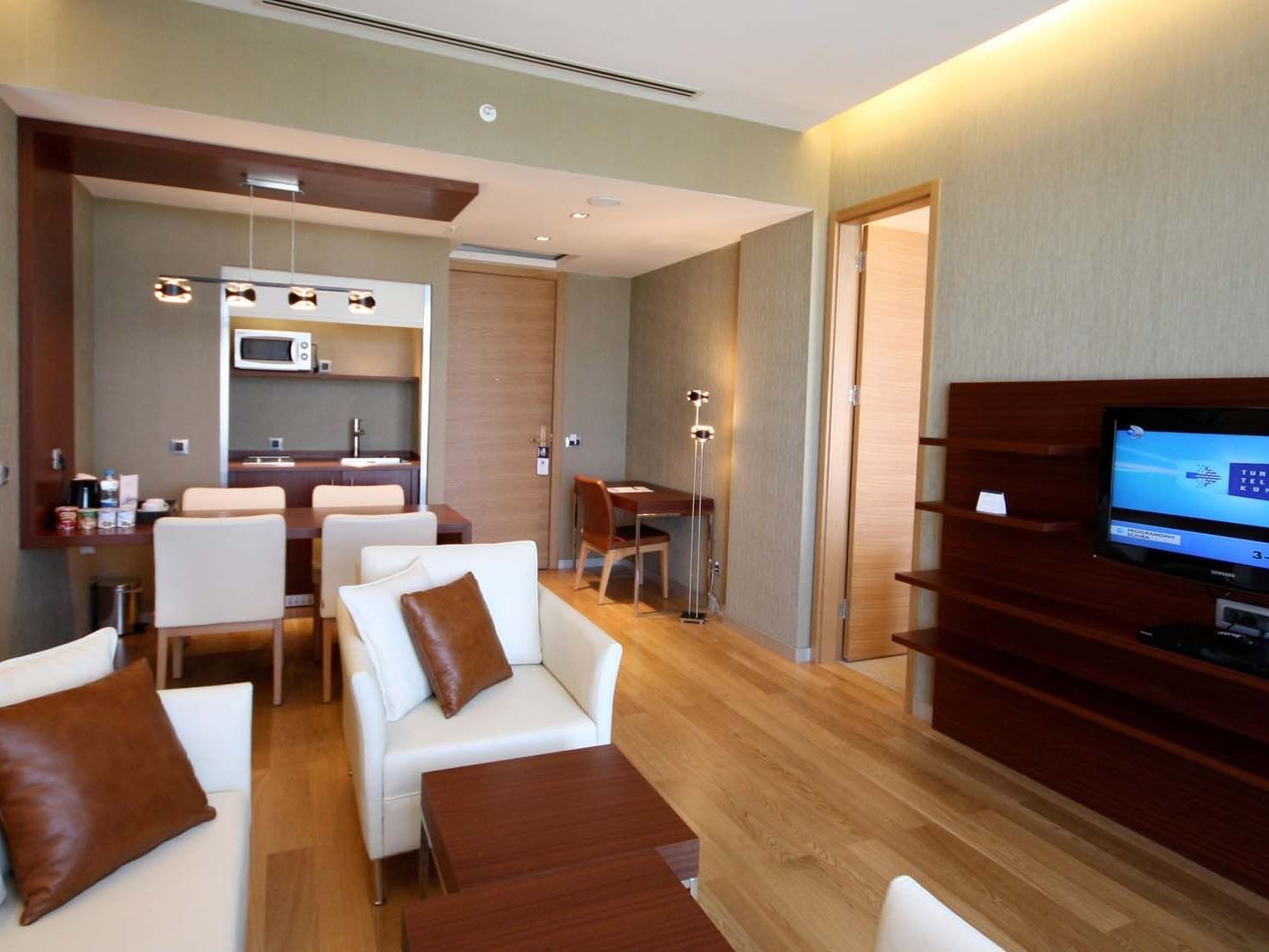 Modern interior with kitchenette, dining area and TV in Suite at Titanic Anadolu Gebze