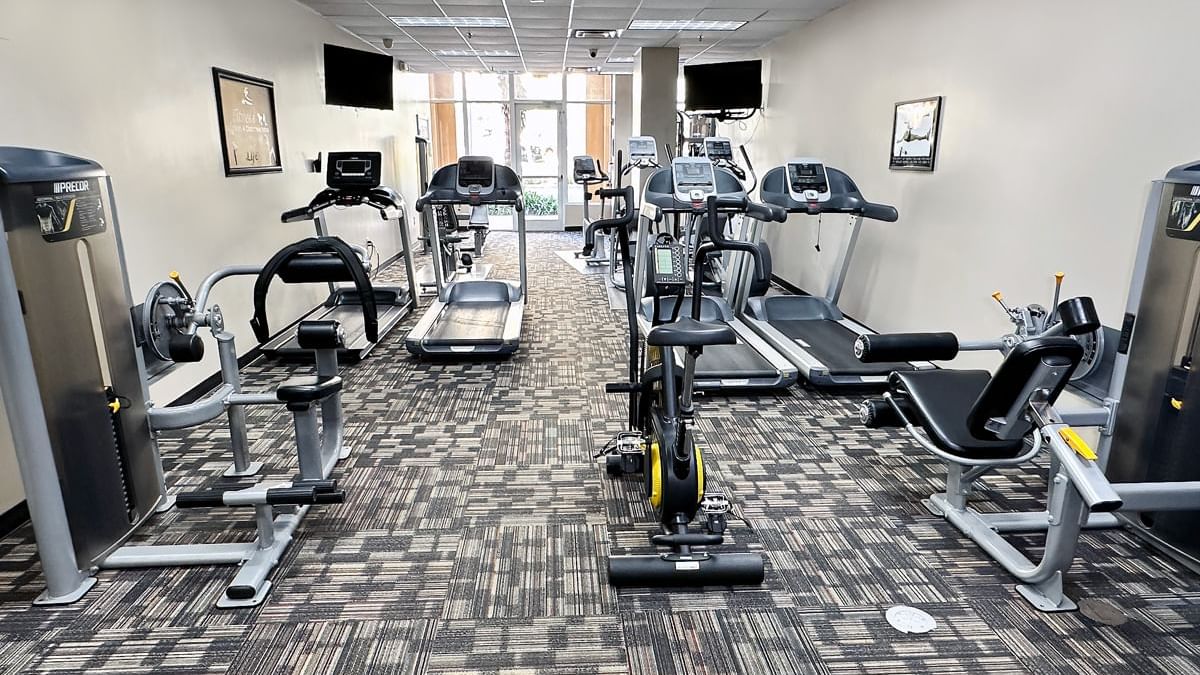 A well-equipped gym with various exercise machines.