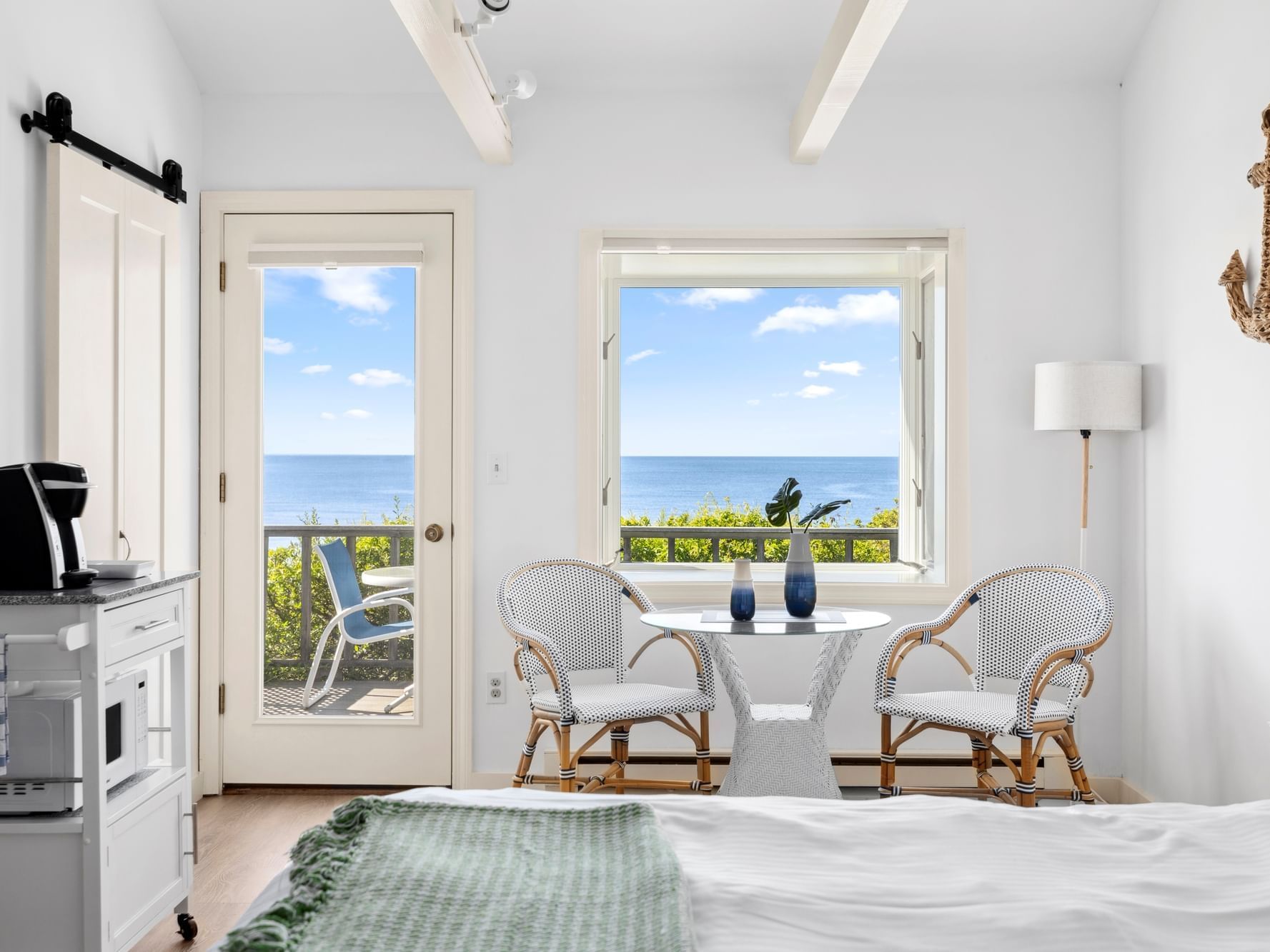 King bed, coffee & microwave cart, and cafe table with two chairs in Oceantide Beachfront King Efficiency at Chatham Tides