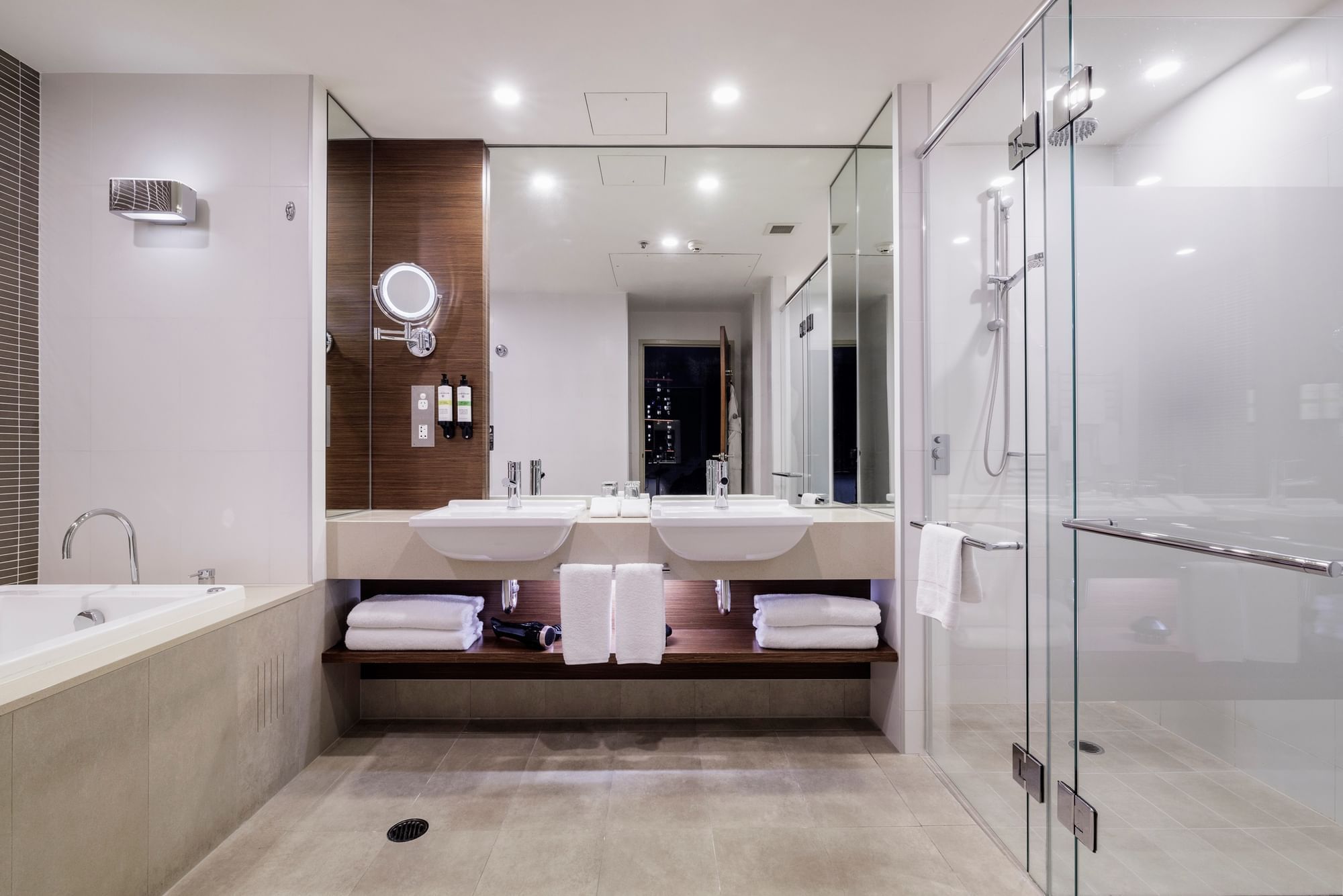 Bathtub by the vanity with glass shower in Pullman Suite Bathroom at Pullman Sydney Olympic Park
