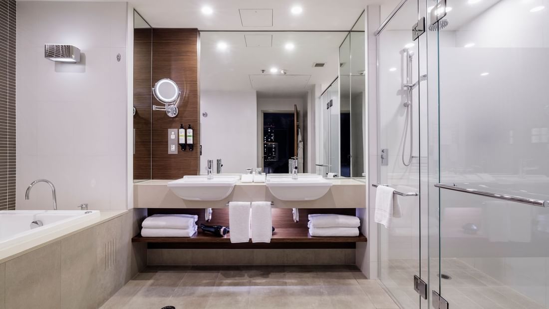 Bathtub by the vanity with glass shower in Pullman Suite Bathroom at Pullman Sydney Olympic Park