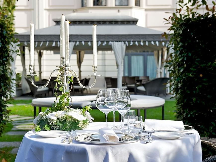 Outdoor dining table set up with glassware & candle holder in V Piano Attico Gourmet Restaurant at Grand Visconti Palace