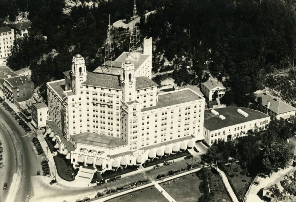 Vintage aerial view of Arlington Resort Hotel & Spa by a curved road