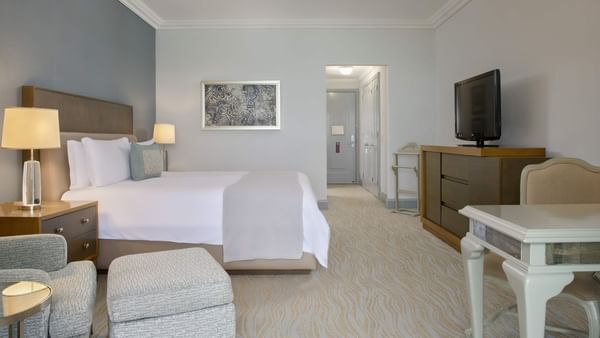 TV & side cupboard facing the bed in Deluxe Seaside King Room at Kempinski Hotel Cancún