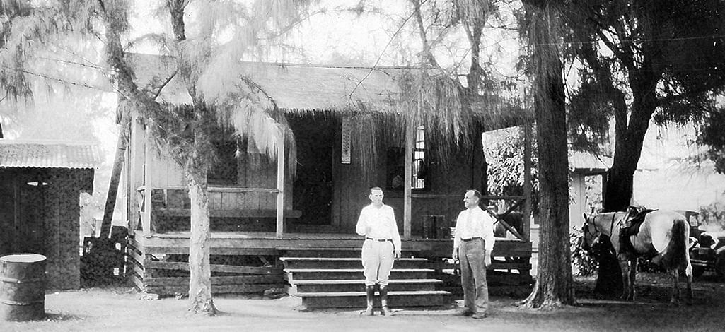 Waimea Plantation Cottages in 1929 with two men and a hors