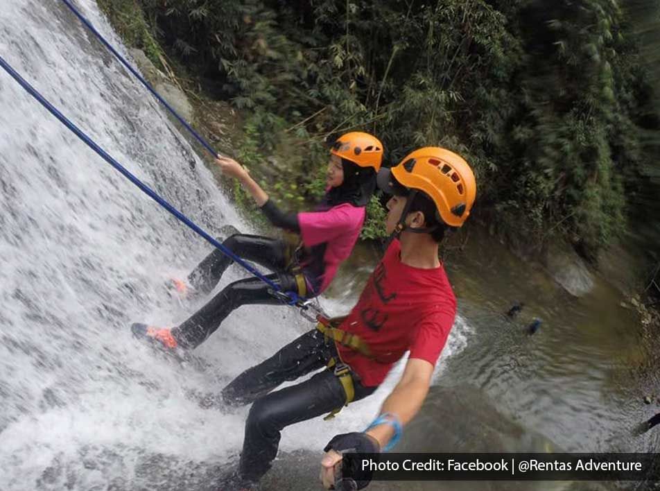 A man and a woman were engaging in the activity of waterfall canyoning - Lexis Suites Penang