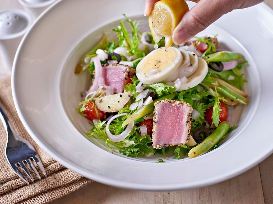 Garnishing salad in The Straits Estate at VE Hotel & Residence