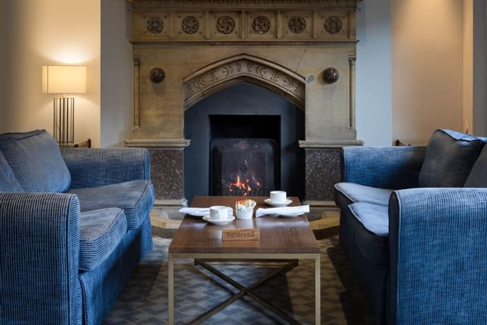 Sofa by the fireplace in Cosy Corner at Bridgewood Manor Hotel