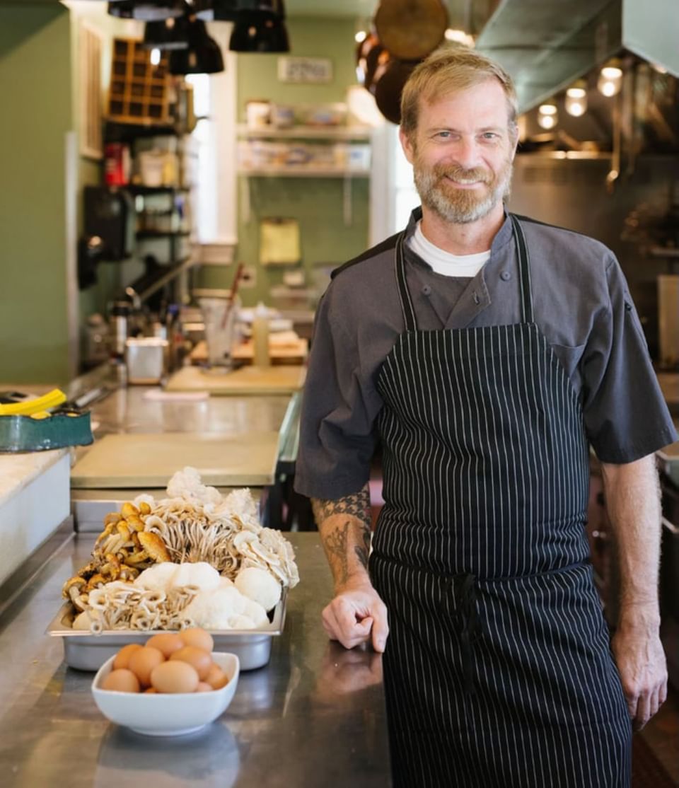 Portrait of Executive Chef Matthew posing in the kitchen at The Clifton