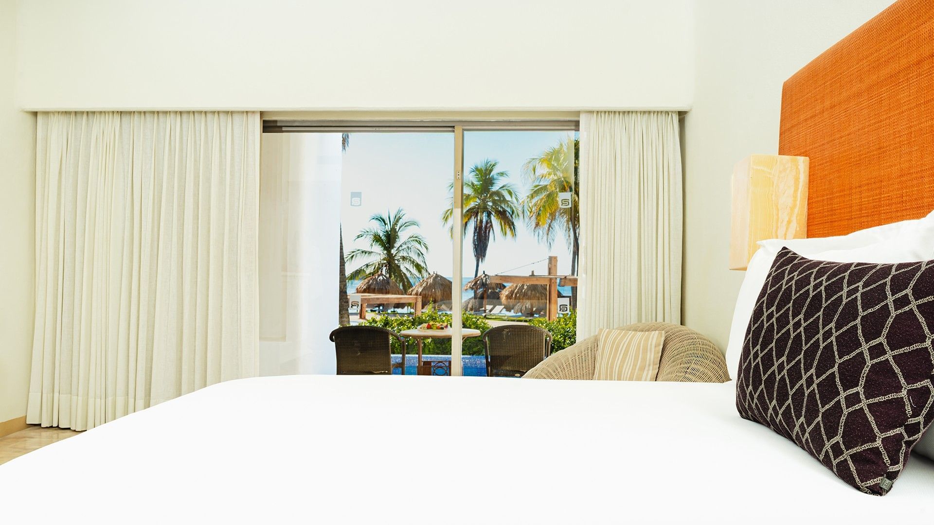 Cozy lounge chair and private balcony seating in King Deluxe Private Pool at Camino Real Zaashila Huatulco