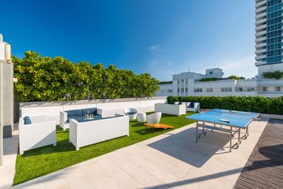 lounge area and table tennis near rooftop pool