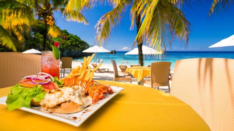 plate of food on table near beach