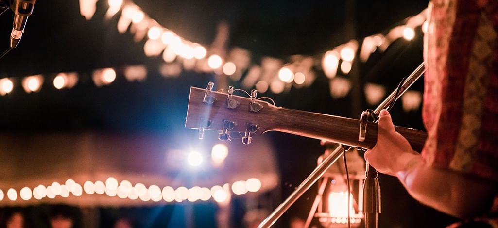 a guitarist performing at a summer night fair