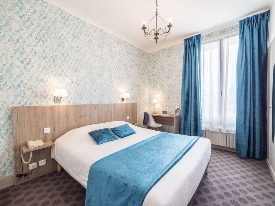 Queen bed in a Comfort Double bedroom at Hotel Normandie