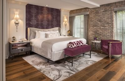 bed in cozy room with carpet and brick wall