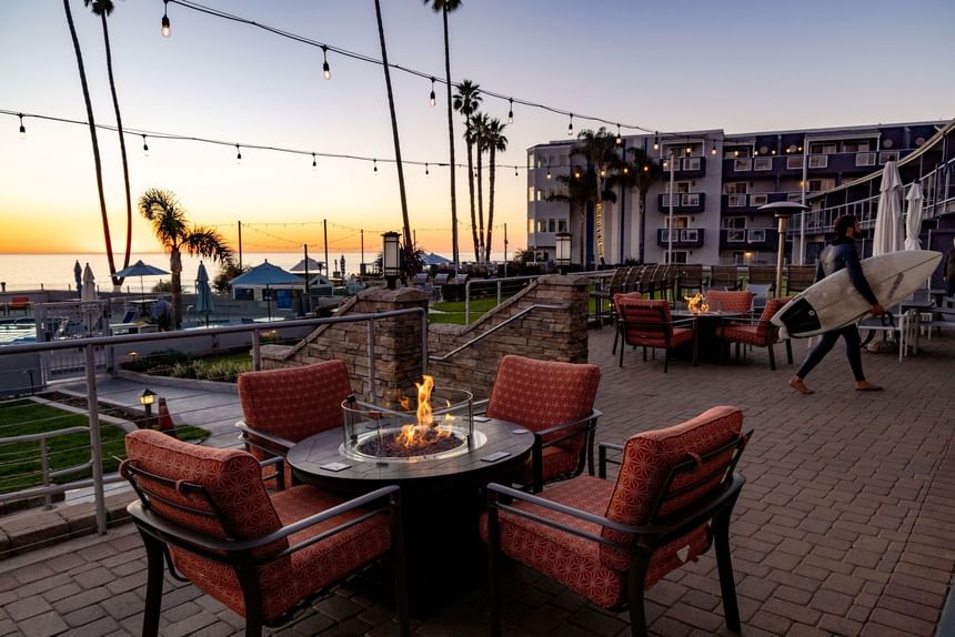 Hotel terrace fire pit with seating at sunset 