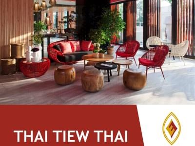 Lounge area with red cane chairs at Eastin Hotels