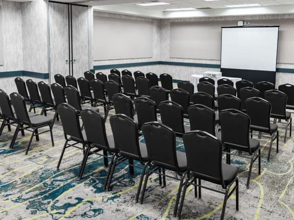 Meeting venue with project screen and chairs