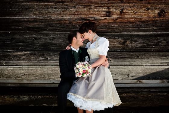 A wedding couple posing outside at Schloss Hotel Pichlarn
