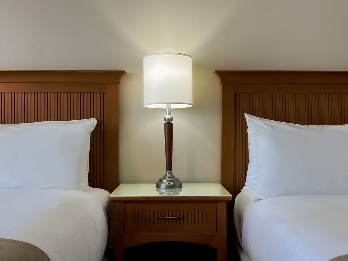 Two queen beds, pillows and lamp