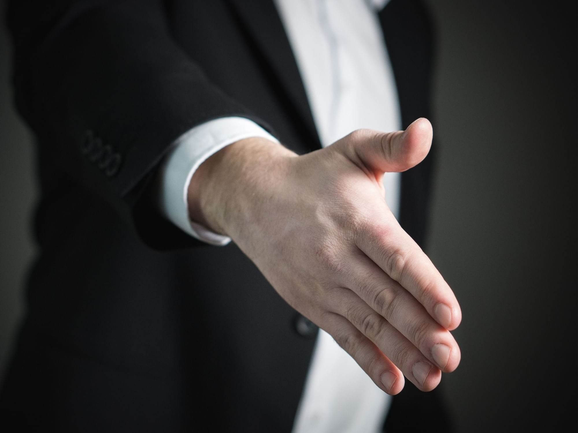 Man giving hand for a handshake at Nesuto Stadium Hotel