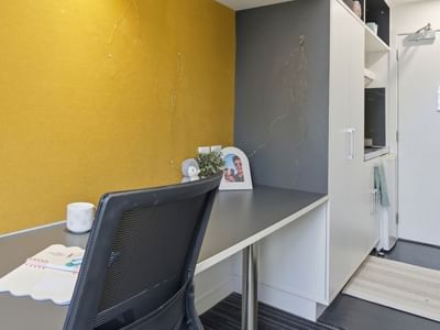 Work area with a desk and chair at UniLodge Auckland City.