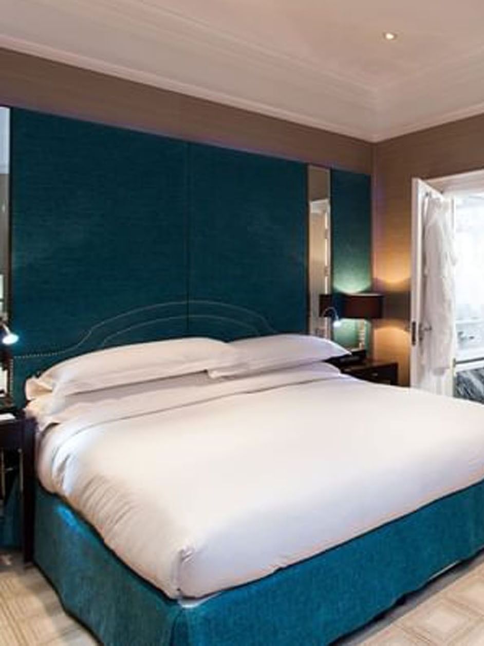 Bed with side tables and working desk near window in Classic Townhouse Room at The Capital Hotel, Apartments and Townhouse