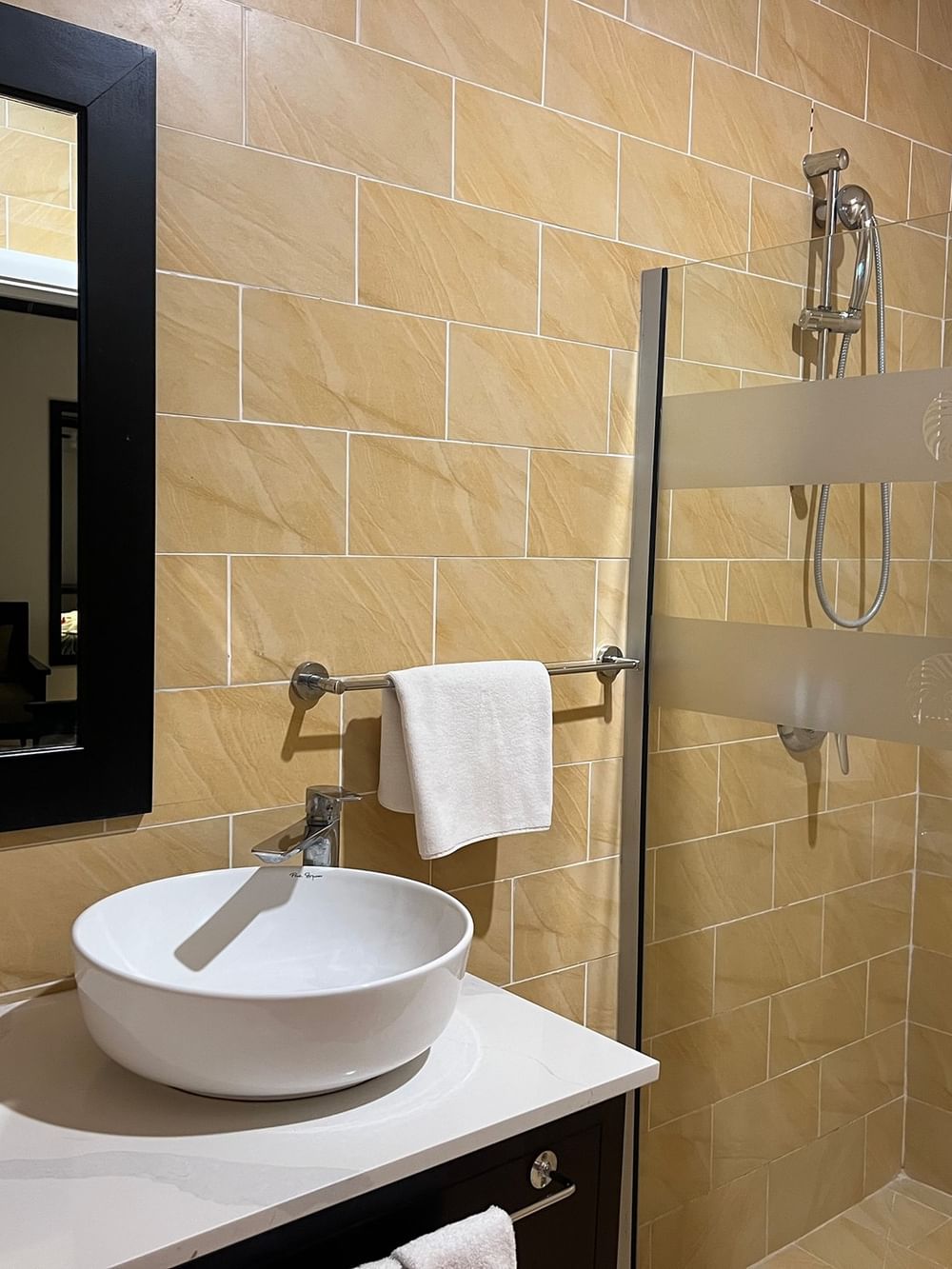 Bathroom with white sink and shower in the Ocean View Villa at Tambua Sands Beach Resort Sigatoka.