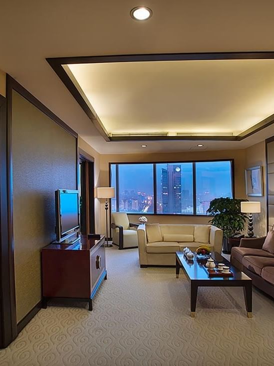 TV lounge with cozy couches by the window in Yu Ting Imperial Suite at Celebrity International Grand Hotel