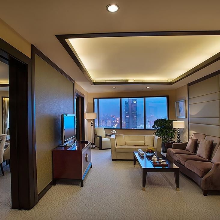 TV lounge with cozy couches by the window in Yu Ting Imperial Suite at Celebrity International Grand Hotel