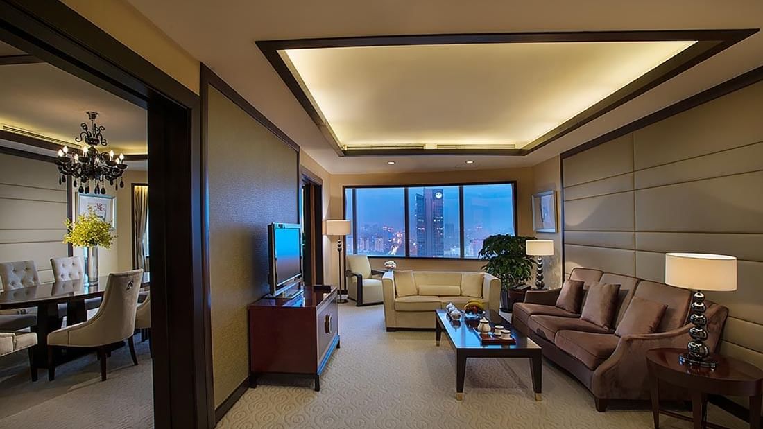 Spacious living area with cozy couches & a TV in Yu Ting Imperial Suite at Celebrity International Grand Hotel