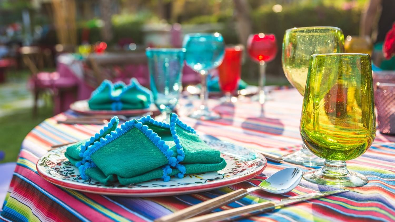 Palapa Fiesta Mexican Dinner table close-up with colorful glasses in Montage at Hacienda del Mar Los Cabos