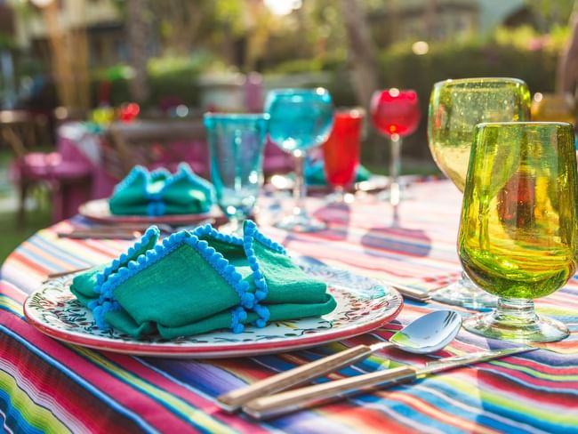 Palapa Fiesta Mexican Dinner table close-up with colorful glasses in Montage at Hacienda del Mar Los Cabos