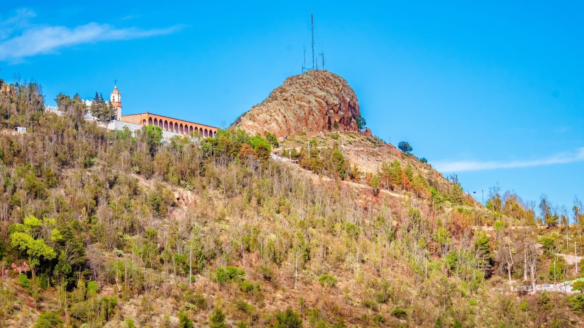 Cerro de la Bufa view of a rugged hilltop with a historic building and lush green trees near Quinta Real Zacatecas