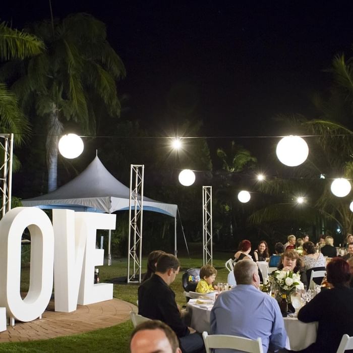 Outdoor night event with love sign & hanging lights at Mercure Hotel Townsville