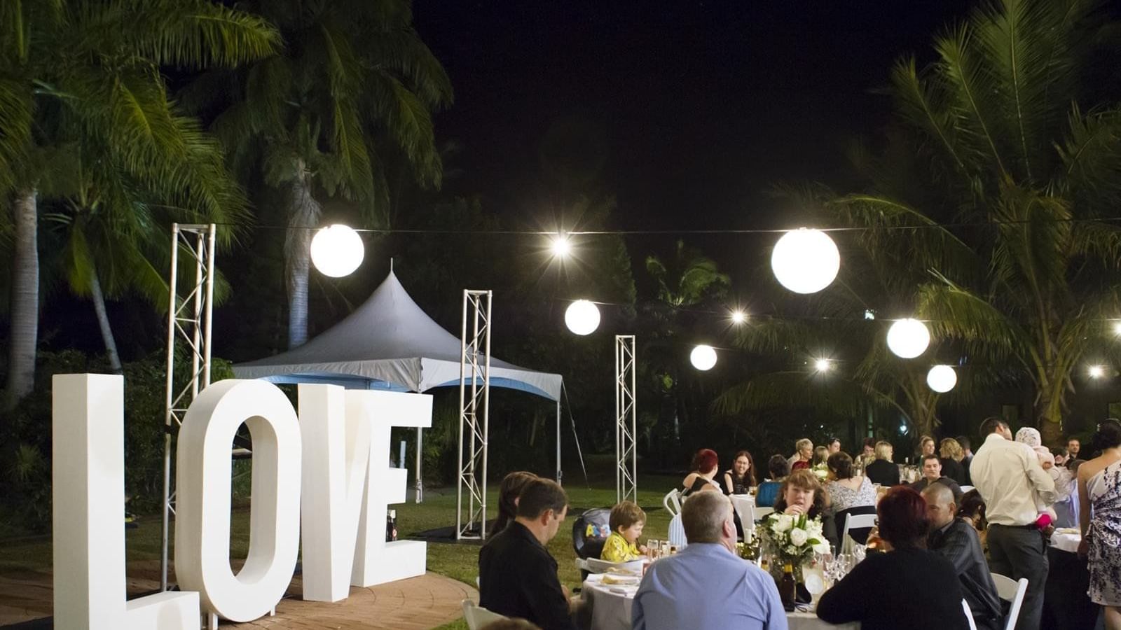 Outdoor night event with love sign & hanging lights at Mercure Hotel Townsville