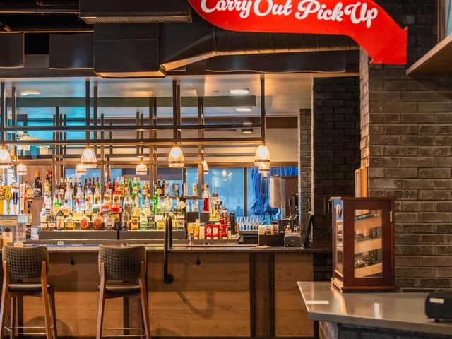 Bar seating with carry out & pick up sign at Doc's Bar & Grill at Shangri-La Resort and Golf Club