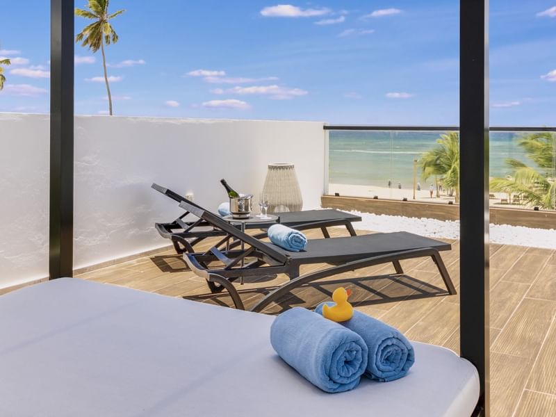 Outdoor lounging area with sunbeds in Viento Suite at Live Aqua Punta Cana
