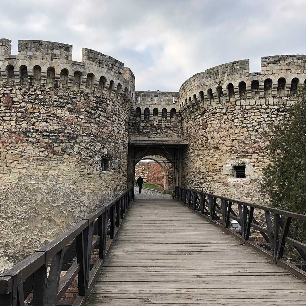 A person walking through the Kalemegdan Fortress entrance near Falkensteiner Hotel Belgrade