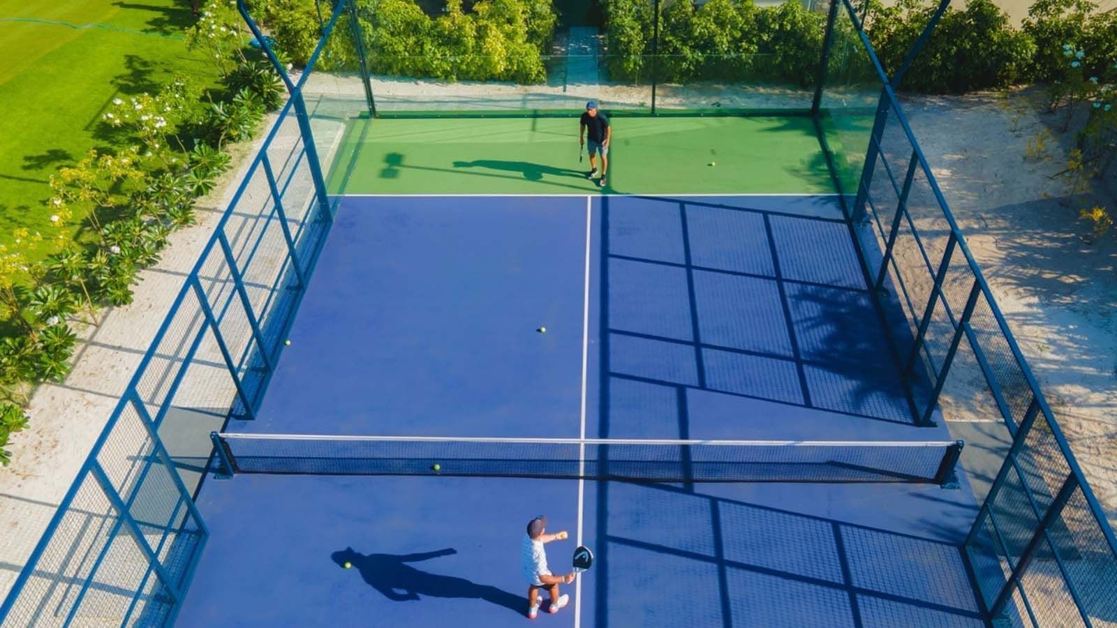 Aerial view of 2 men playing tennis at The Signature Collection