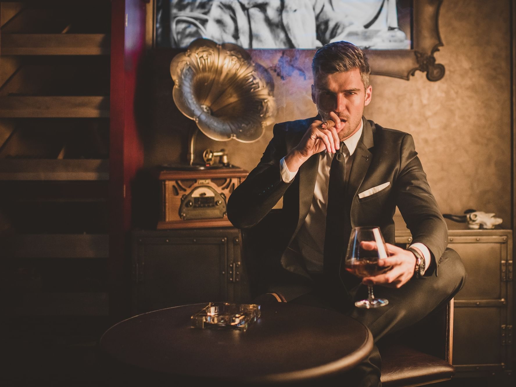 Guy holding a drink in Speakeasy Bar at Paramount Hotel Dubai