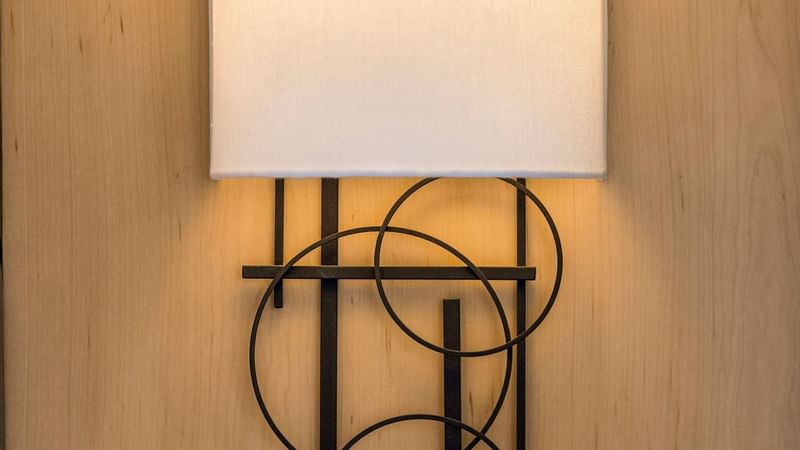 Close-up of a wall light hanging on the wall in Accessible Deluxe Room at Warwick Seattle