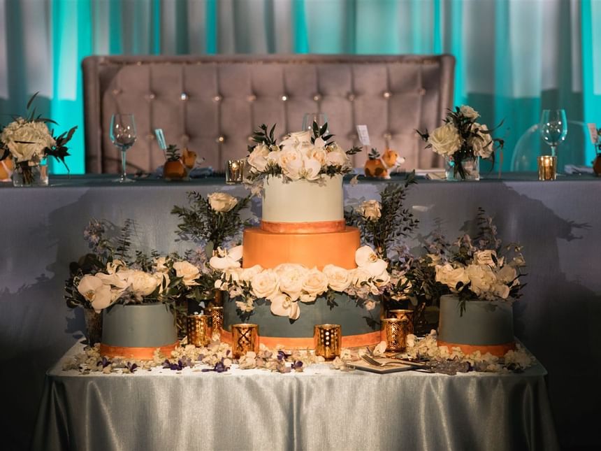 Wedding cake with flowers & candles at Carriage House Hotel