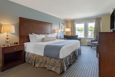 Nightstands & seating area by the bed in Deluxe King Room at Union Bluff Hotel