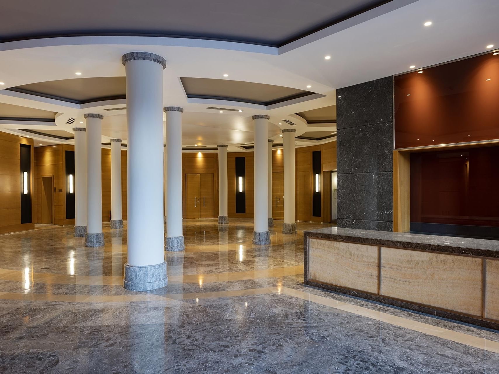 Luxurious meeting room lobby with marble and wood accents at Titanic Luxury Collection Bodrum.